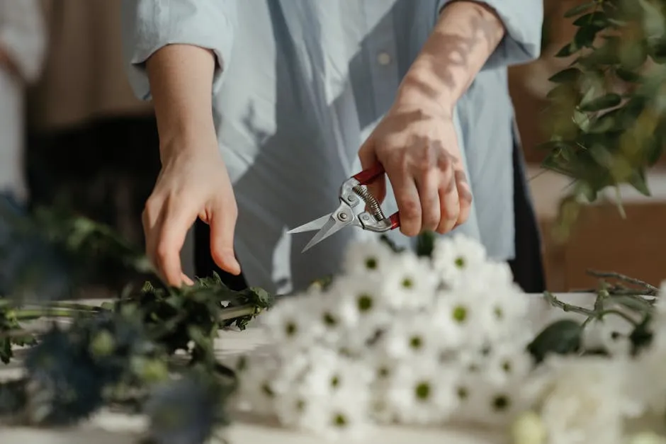 Person in White Dress Shirt Holding Silver and Red Scissors