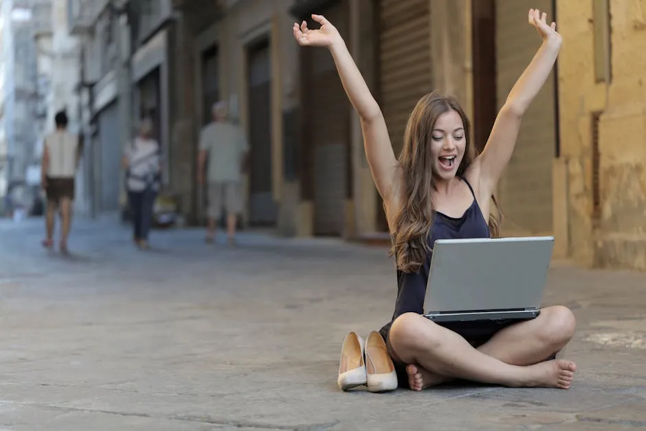 Woman Raising Her Hands Up While Sitting on Floor With Macbook Pro on Lap