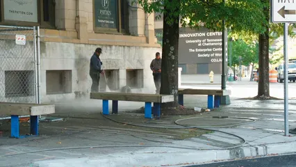 Horizontal video: Man cleaning the sidewalk with a power spray 6160410. Duration: 27 seconds. Resolution: 3840x2160