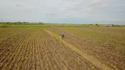 Horizontal video: A person plowing cropland using a tractor 2300433. Duration: 13 seconds. Resolution: 1920x1080
