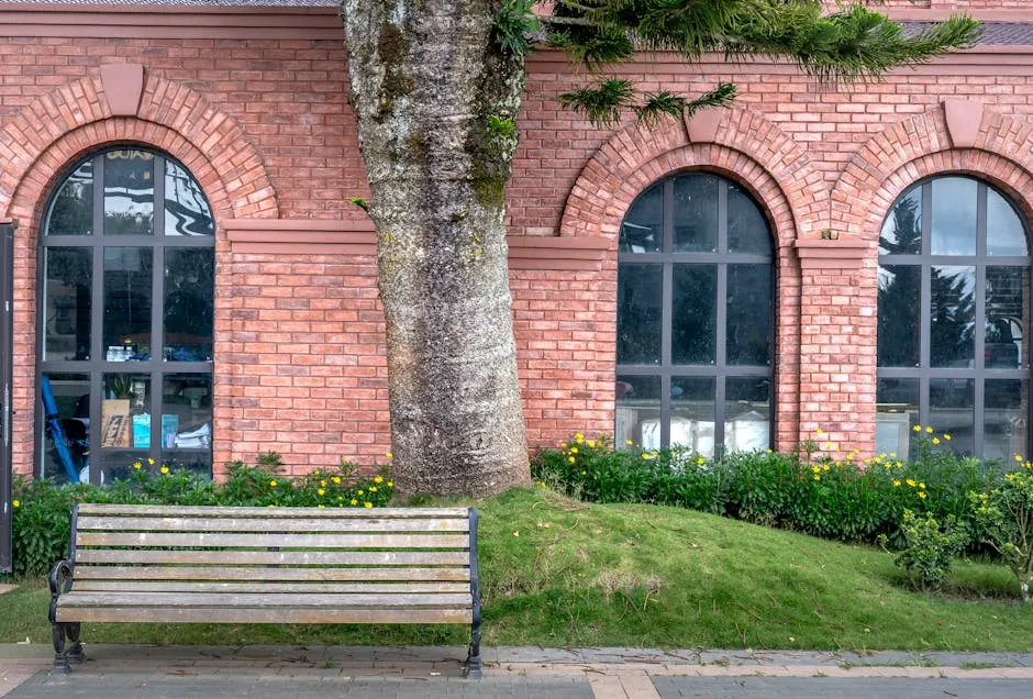 Charming Brick Building with Bench and Garden View