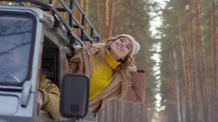 Horizontal video: A woman leaning out from a vehicle window enjoying the surroundings and fresh air 3195812. Duration: 9 seconds. Resolution: 3840x2160