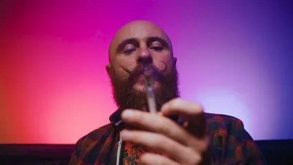 Horizontal video: A man blowing marijuana smoke 8425525. Duration: 12 seconds. Resolution: 3840x2160