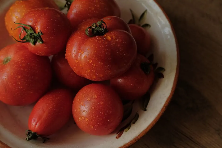 A bowl of tomatoes on a wooden table