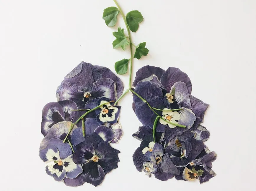 A Cluster of Pressed White and Purple Flowers with Green Leaves