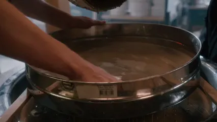 Horizontal video: A person mixing a liquid clay on a stainless tray 9736237. Duration: 11 seconds. Resolution: 3840x2160