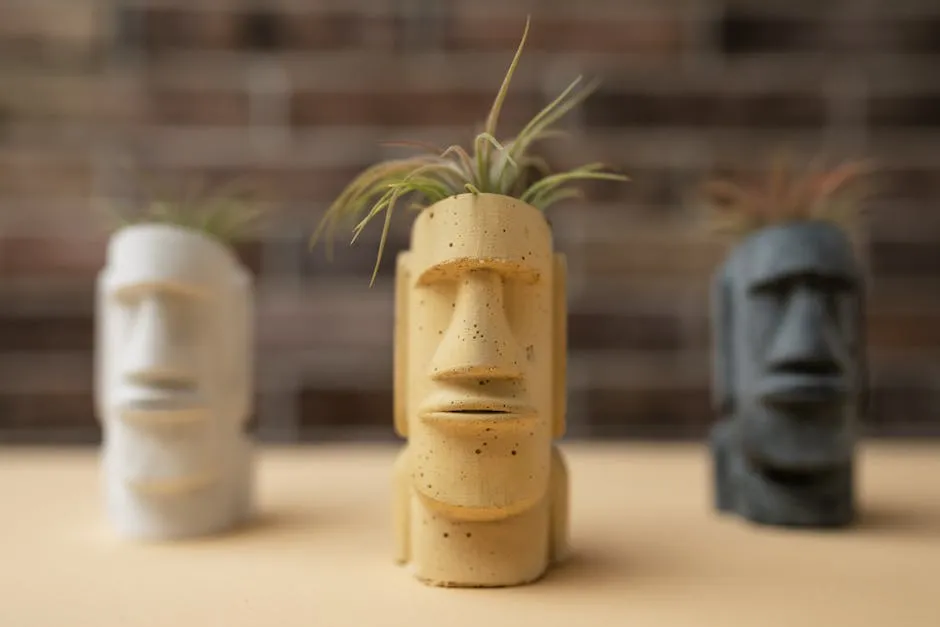 Three Moai-style planters featuring succulents, showcasing creative and cultural design.