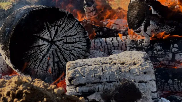 Horizontal video: Burning logs with vibrant flames outdoors 29185903. Duration: 7 seconds. Resolution: 3840x2160